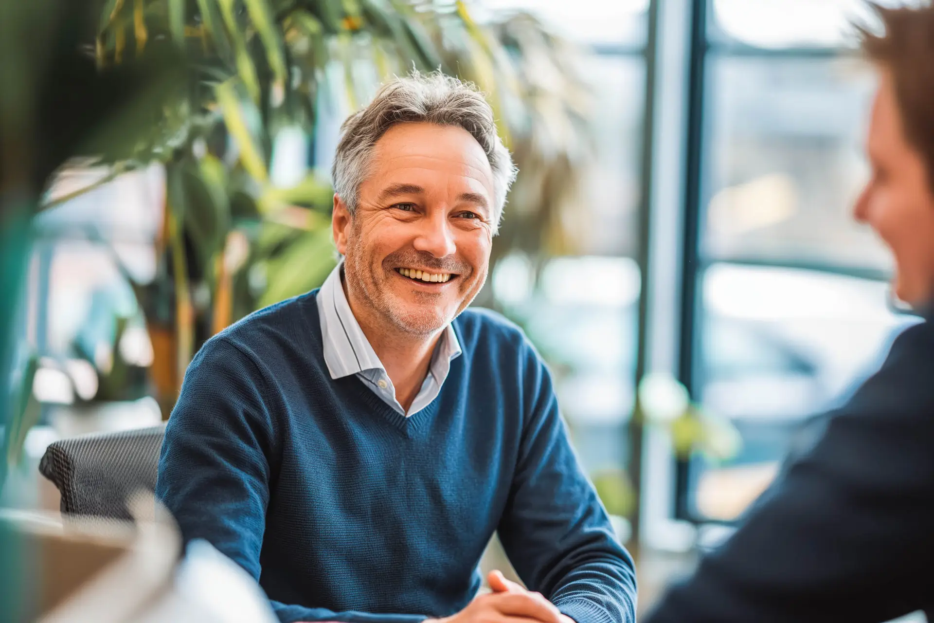 Experienced consultant advising a younger colleague in a meeting